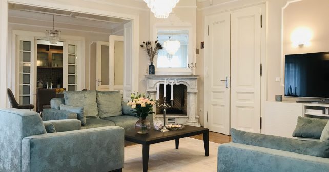 Large living room with 3 luxury light-blue colored sofas