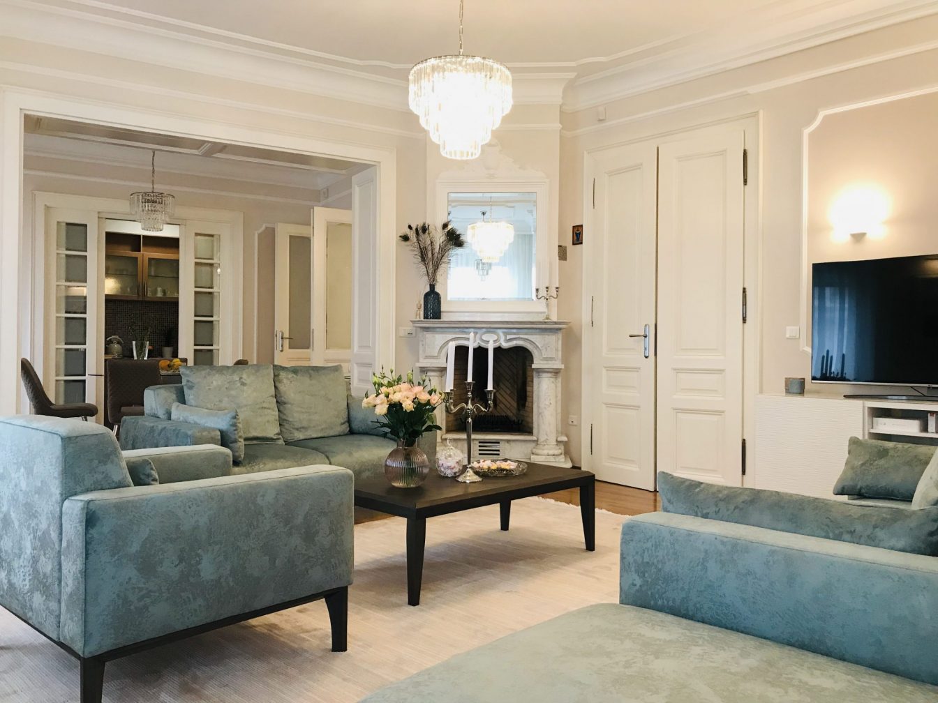 Large living room with 3 luxury light-blue colored sofas