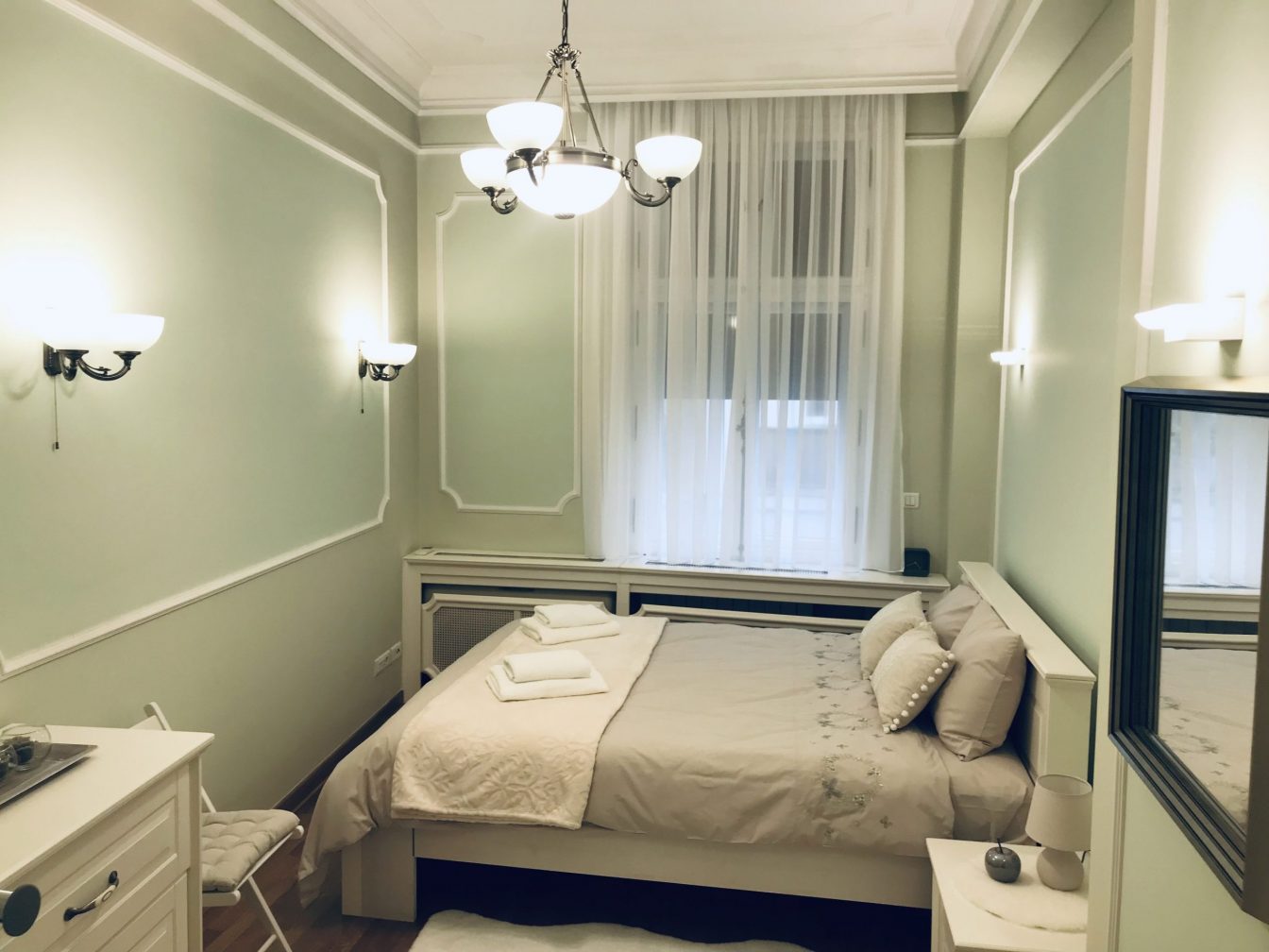 Queen size bed with light green sheets